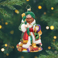 A Feast for the Present. Ornament of Ghost of Christmas Present wearing a green robe surrounded by a variety of foods and other goodies. View of front