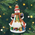 The Jingle Gent. A snowman ornament dressed in a red and gold robe  with a matching top hat, surrounded by and holding presents. View of front.