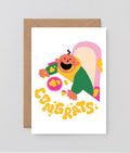new baby card with baby covered in food and congrats spelled out in splat marks on the table