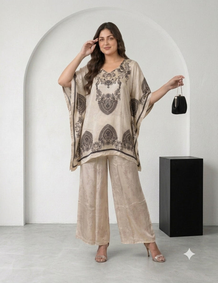 Model wearing a beige silk kaftan set with dark brown print and matching trousers.