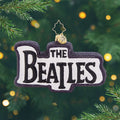 British Beats. A white ornament with black sparkly trim and "The Beatles"
written in the center. View of front
