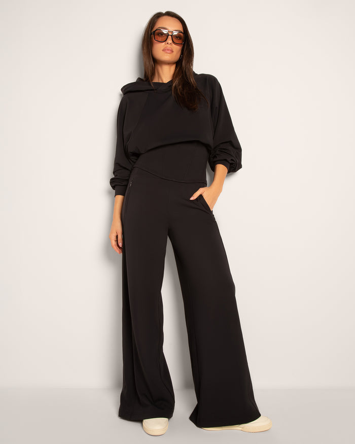 Model posing in Cloudlined Corset Hoodie and Cloudlined Wide Leg Pant - Soft Black  full body front view