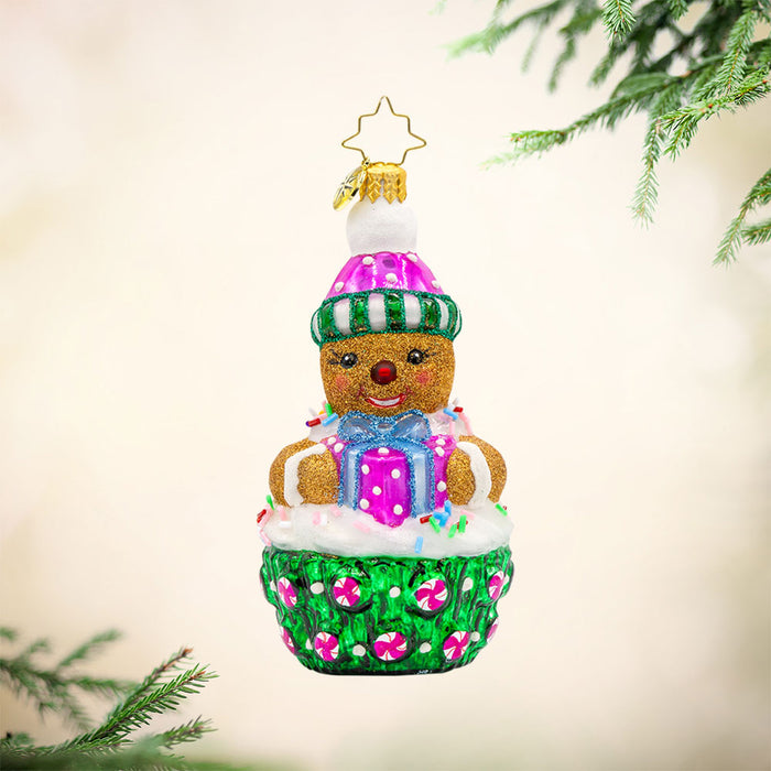 Cookie Cutie ornament. This gingerbread man is perched atop a green and pink cupcake. View of front.