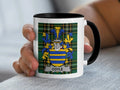 Mug with the COYLE family crest on a tartan background.