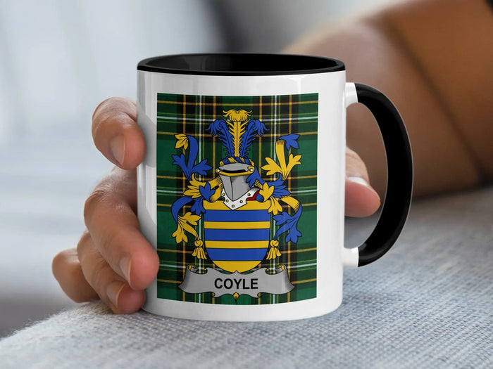 Mug with the COYLE family crest on a tartan background.