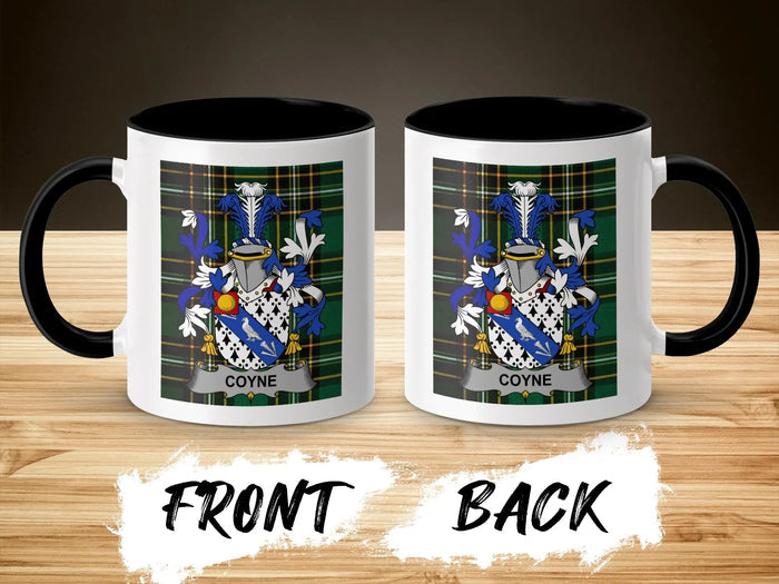 Two white mugs with black handles displaying a family crest with "COYNE" text.
