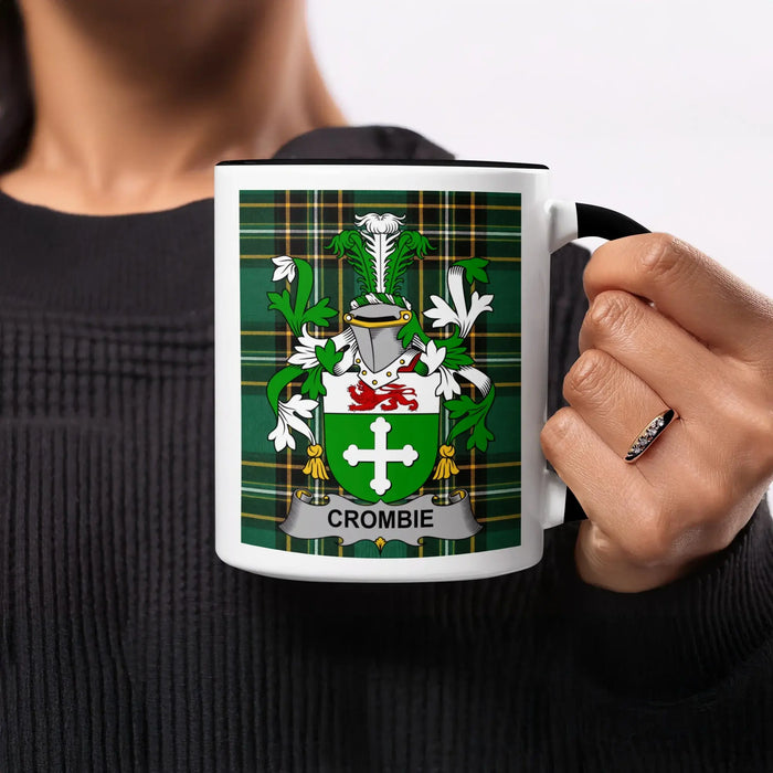 White mug with black handle displaying the Crombie clan crest on green plaid.