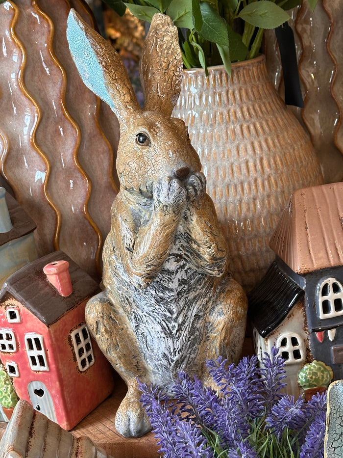 Decorative Rabbit with Paws on Mouth