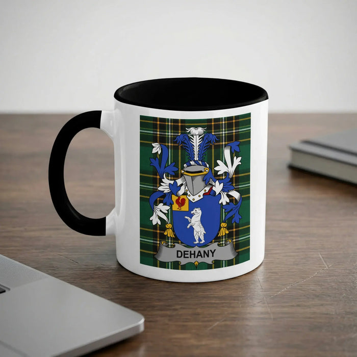 White mug with black handle featuring the DEHANY family crest on a green plaid background.
