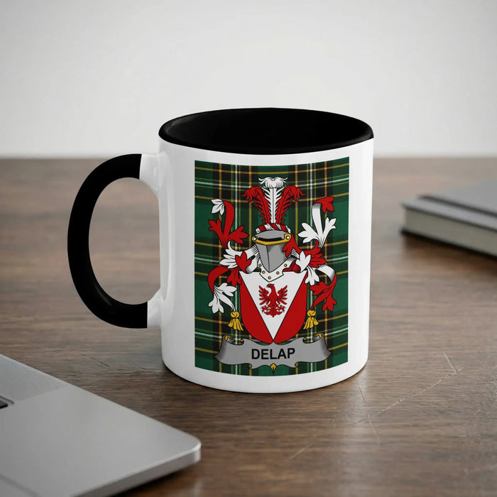 White mug with black handle and rim, featuring a red and green plaid crest with the name DELAP.