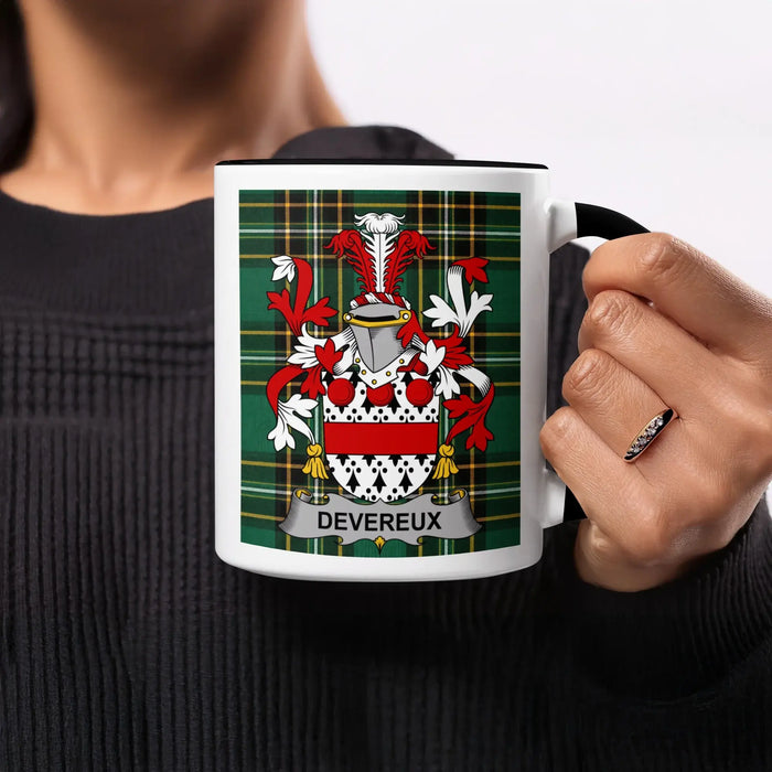 Mug with Devereux coat of arms on tartan background held by a person.