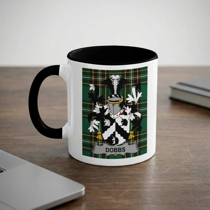 White mug with black rim featuring a green plaid coat of arms with "Dobbs" banner.