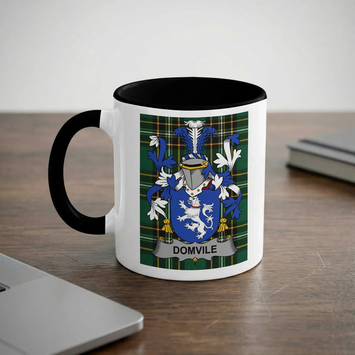 White mug with black rim featuring a green plaid shield with a crest and the text "DOMVILE".