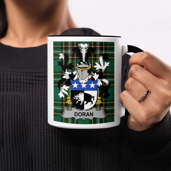 Mug with Doran coat of arms on green plaid background.
