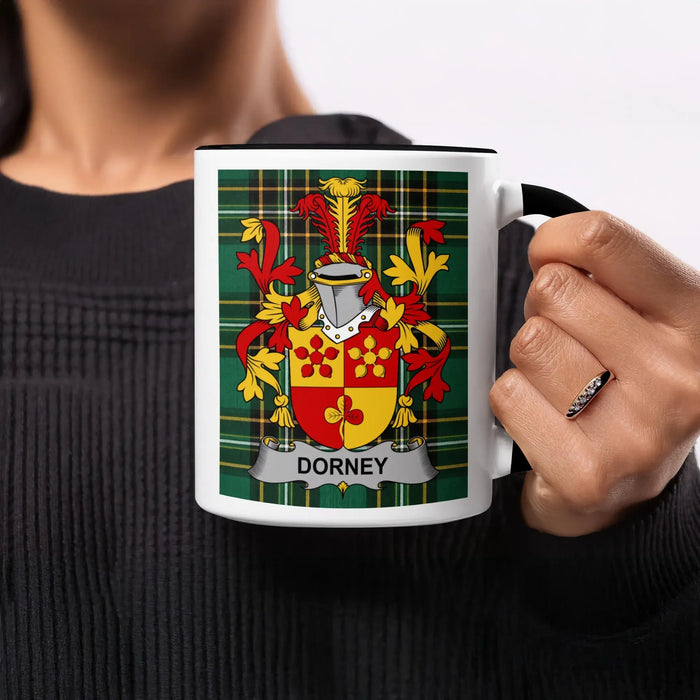 Black mug with Dorney family crest on tartan background.