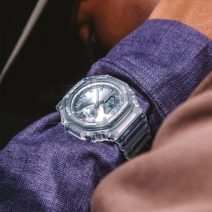 Transparent GA2100BM-7A8 45.4mm silver watch on a purple shirt sleeve
