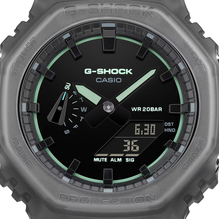 Detailed view of GA2100K-1A watch face with black dial green accents and digital readout on a grey resin bezel