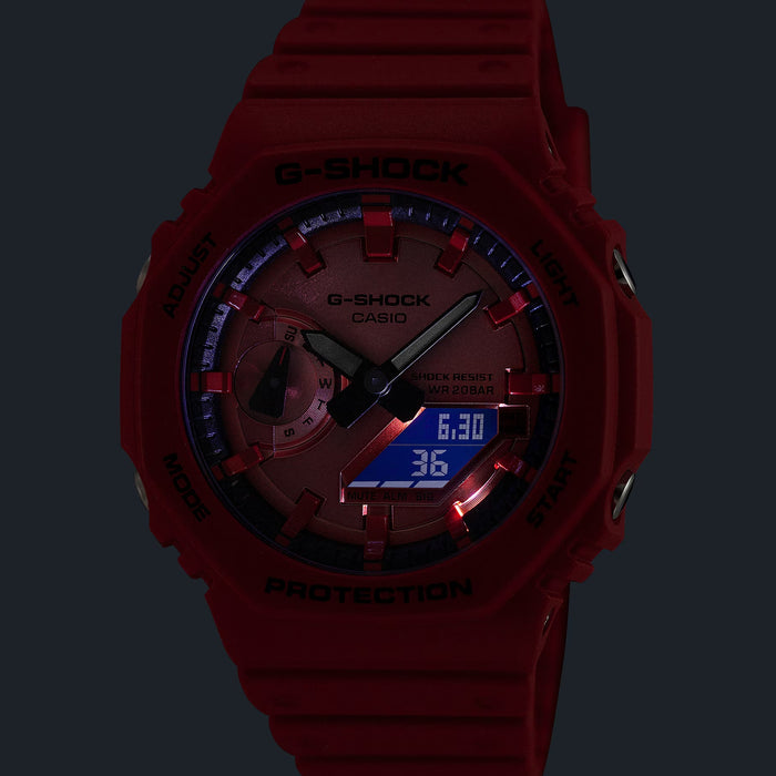 Close up of red GA2100RRB-4A watch face with red dial and bezel against a dark backdrop
