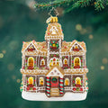 Gingerbread Manor. A gingerbread man mansion in a sparkling light and dark brown with golden windows and green and red gems and white detailing's. View of front