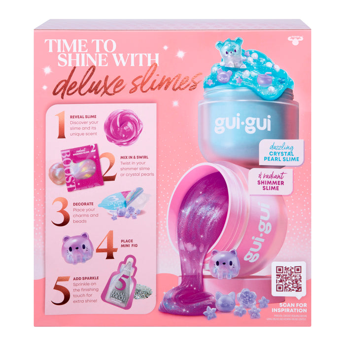 A pink Gui Gui Shimmer Deluxe Duo Pack box features a DIY slime kit with step-by-step images for making sparkling purple slime, plus crystals, charms, glitter, a jar, and decorations to customize your creation.