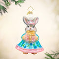 Hoppy Holiday ornament. This bunny is dressed in a blue and pink dress, with a gift in hand. View of front.