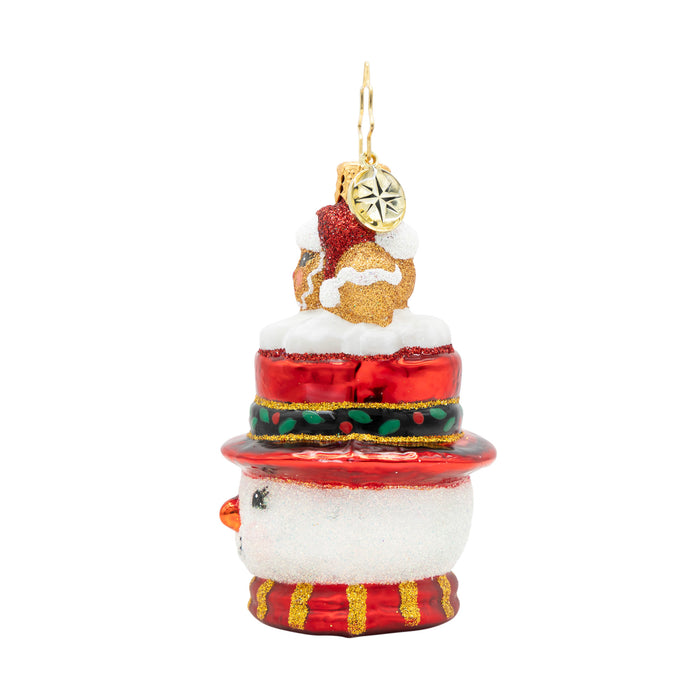 Side of a decorative side of a  snowman Christmas ornament shaped with a gingerbread man on top, on a white background.
