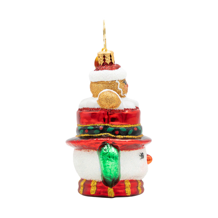 Side of a decorative side of a  snowman Christmas ornament shaped with a gingerbread man on top, on a white background.