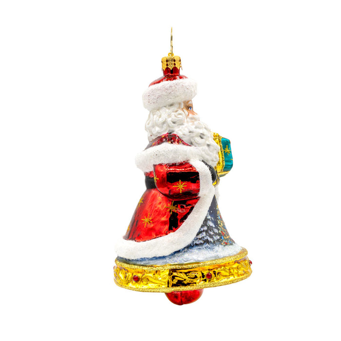 Jingle All The Claus ornament. The bottom of Santa's body creates a bell. The hand-painted scene on his coat features a snowy village and a twinkling Christmas tree. View of left side.