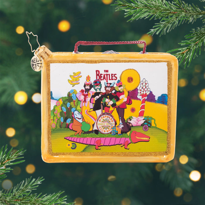 Lets Do Lunch. Golden ornament in the shape of a lunch box with the Beatles on the front in a colorful scene.