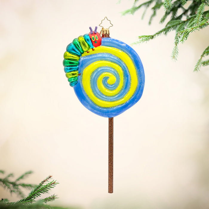 Lollipop Caterpillar. Ornament shaped as a lollipop in colors of blue and yellow with the hungry caterpillar on top. View of front