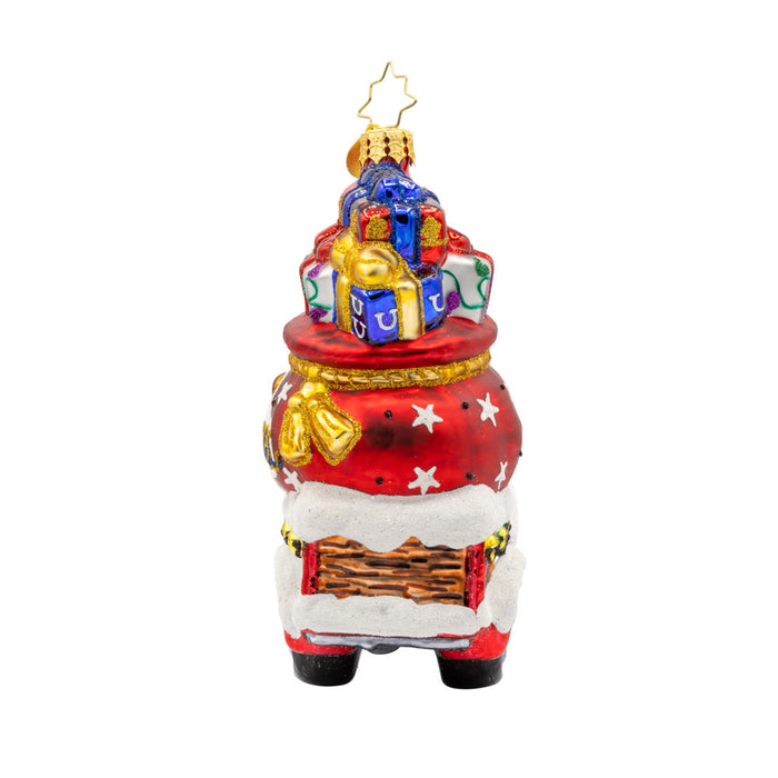 Lone Star Santa Cruiser ornament. Santa's driving a car with a Texas gift bag in tow. View of right side.