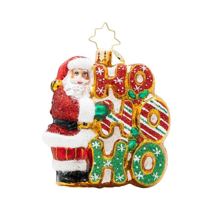 Christmas ornament with Santa Claus holding a 'HO HO HO' sign on a white background
