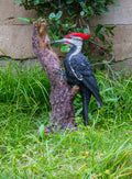 Pileated Woodpecker on a tree trunk Garden Statue HI-LINE GIFT LTD.