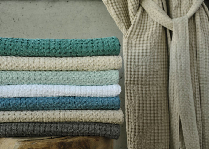 A&H Pousada Waffle Towels (top-to-bottom) in 302 Lagoon, 101 Ecru, 235 Ice, 100 White, 325 Dragonfly, 770 Linen and 920 Gris. A&H Pousada Robe in 770 Linen