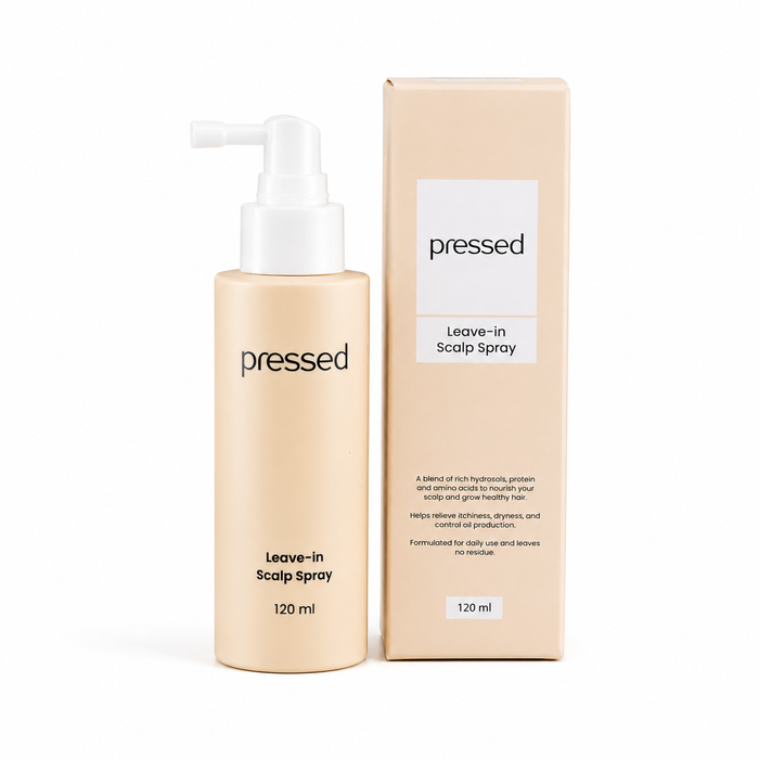pressed leave-in scalp spray and box 120ml bottle with white pump on a white background
