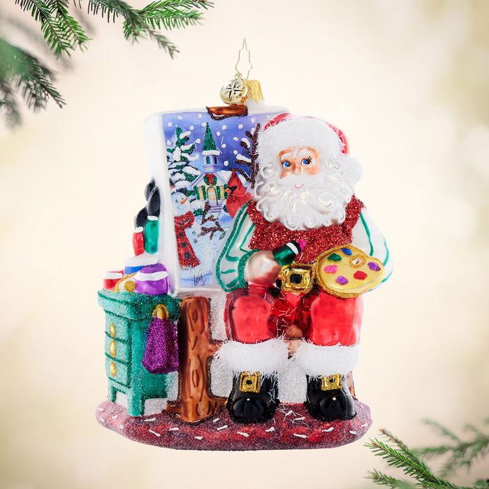 Front image - Pretty as a Picture - (Painting Santa ornament) - Ornament of Santa painting a night scene and surrounded by paints