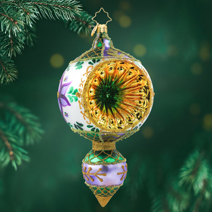 An ornament designed in Traditional folk of Central European Artists from the 1930’s are the basis of Christopher Radko’s FANTASIA ornaments. It features beautiful hand painted polish folk designs with a single reflector in gold and colors of white, purple, and green. View of front