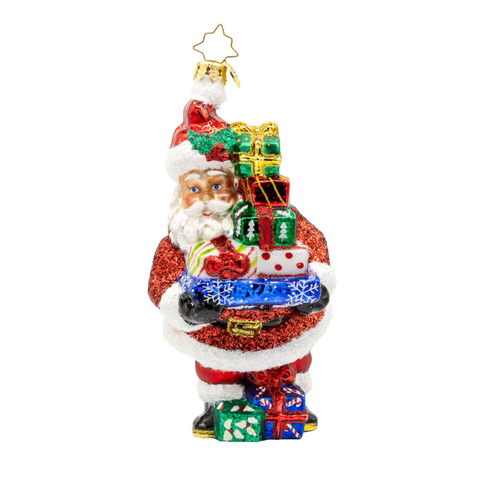 Santa's Surprise Stash ornament.  Features Santa carrying a tower of  festive presents. View of front.