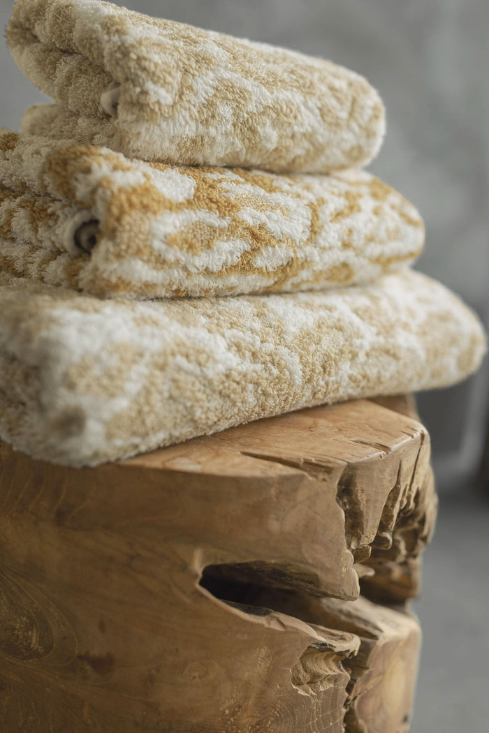 A&H Sauvage Towels, top-to-bottom: 714 Sand, 840 Gold & 714 Sand. Crafted from 100% Egyptian Cotton Extra-Long Staple