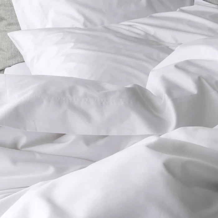 St Genève Sintra 300 thread count percale bedding in crisp white. Available in duvet covers, flat/fitted sheets, shams and pillowcases