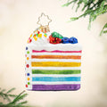 Slice Of Joy Gem. Ornament of a cake slice with rainbow stripes and sprinkles. View of front