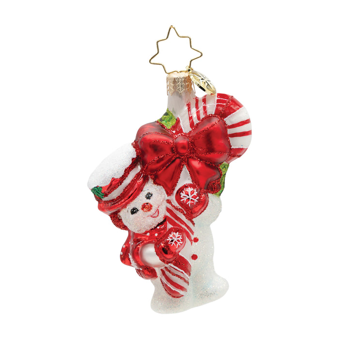 Decorative ornament of a snowman with a large red bow and candy cane, on a white background.