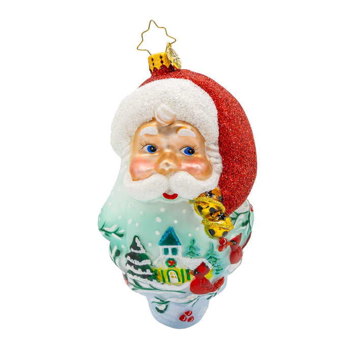 St Nick's Winter Tale ornament. Santa's smiling face and snowy scene with intricate details and a hand-painted beard. View of front.