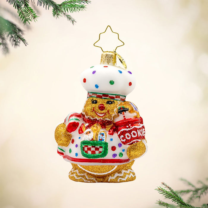 Sugary Chef Gem ornament. This gingerbread man is dressed as a baker with a cookie jar in hand. View of front.
