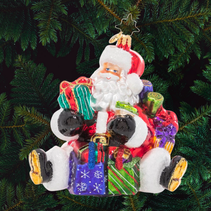 Ornament Description - That's a Wrap Santa!: No surprise that the Christmas king is also a major wrap star! Santa's ready to give with his arms loaded with lovingly-wrapped presents in every size and shape.