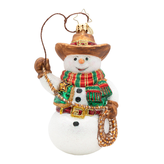Front view of a snowman ornament with cowboy hat, red, gold and green striped scarf, and lasso. Green vest with gold badge detail. Red and gold buckled belt. Placed on a white background.