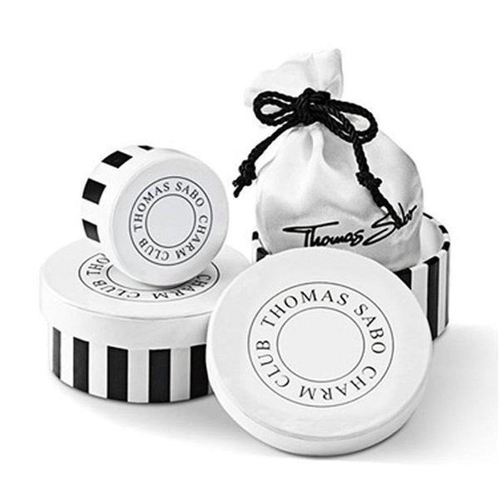 Yellow cab charm in elegant black and white striped packaging.